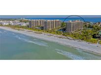 Aerial view of beachfront condo building with resort amenities at 1211 Gulf Of Mexico Dr # 211, Longboat Key, FL 34228