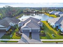 Luxury home with lake view, two-car garage, and paver driveway at 2616 Sapphire Blue Ln, Bradenton, FL 34211