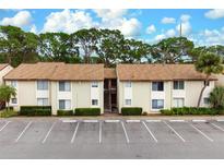 Two-story condo building with parking and lush landscaping at 2744 Hidden Lake Blvd # A, Sarasota, FL 34237