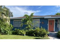 Charming bungalow with a blue exterior, landscaping, and a welcoming front porch at 3008 7Th N Ave, St Petersburg, FL 33713