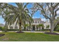 Stunning two-story home with lush landscaping and a stately facade at 370 Sugar Mill Dr, Osprey, FL 34229
