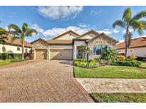 Single-story home with stone accents, tile roof, and a paved driveway at 7014 Whittlebury Trl, Lakewood Ranch, FL 34202