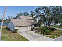 Two-story house with attached garage, landscaping, and a paved driveway at 8006 Oak Dr, Palmetto, FL 34221