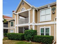 Two-story condo building with balcony and manicured landscaping at 9481 Highland Oak Dr # 1403, Tampa, FL 33647