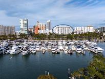 Aerial view of waterfront condo building with marina and city skyline at 101 S Gulfstream Ave # 10E, Sarasota, FL 34236