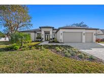 Beautiful new construction home with 3-car garage and lush landscaping at 11323 Rivers Bluff Cir, Lakewood Ranch, FL 34202