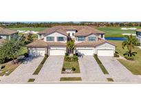 Luxury 3-unit building with tile roofs, attached garages, and a golf course view at 5904 Wake Forest Run # 102, Bradenton, FL 34211