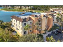 Aerial view of upscale condo building with lake and golf course views at 6474 Watercrest Way # 202, Lakewood Ranch, FL 34202