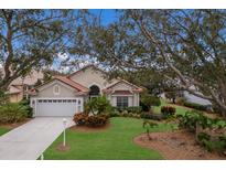 Single-story home with tile roof, attached garage, and landscaped yard at 6726 Virginia Xing, University Park, FL 34201