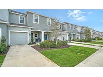 Two-story townhome with attached garage and landscaped front yard at 8533 Lunar Skye St, Sarasota, FL 34241