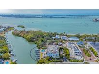 Aerial view of waterfront community with lush landscaping and private boat docks at 888 S Orange Ave # 3D, Sarasota, FL 34236