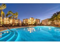 Night view of resort-style pool with building reflection at 9203 Griggs Rd # B304, Englewood, FL 34224