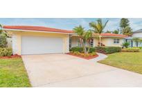 Updated Florida ranch home with a large driveway and mature landscaping at 1110 2Nd S Ave, Tierra Verde, FL 33715