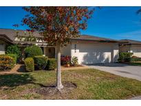 Charming home with a well-maintained lawn, manicured shrubs, and a two-car garage at 3663 Muirfield Dr # 4B, Sarasota, FL 34238