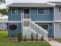 Inviting condo exterior with stairs and landscaping at 6033 34Th W St # 138, Bradenton, FL 34210