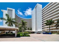 Oceanfront condo building with palm trees and courtyard at 6300 Midnight Pass Rd # 708, Sarasota, FL 34242