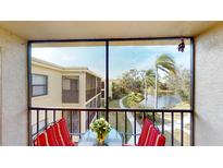 Screened balcony overlooks a peaceful lake and lush landscaping at 305 30Th W Ave # A308, Bradenton, FL 34205