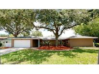 Single-story house with a white garage door and landscaped yard at 5408 18Th Avenue W Dr, Bradenton, FL 34209