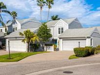 Two-story townhome with gray siding, attached garages, and landscaped lawn at 3523 52Nd W Ave, Bradenton, FL 34210