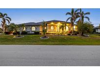 Luxury home with palm trees and landscaped lawn at 3607 Darin Dr, Punta Gorda, FL 33950