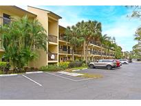 Two-story condo building with ample parking and lush landscaping at 425 30Th W Ave # C102, Bradenton, FL 34205