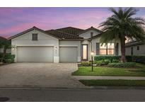 Beautiful two-story home with a three-car garage and lush landscaping at 6519 Rosehill Farm Run, Bradenton, FL 34211