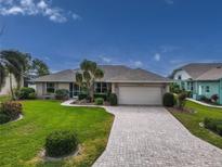 Single-story home with a paved driveway and landscaped yard at 8608 53Rd W Ave, Bradenton, FL 34210