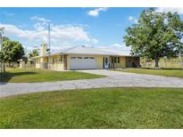 Ranch-style home with a metal roof and large yard at 33931 Serene Dr, Punta Gorda, FL 33982