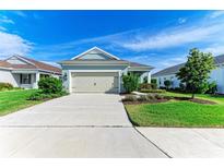 Single-story home with attached garage and well-manicured lawn at 4716 Foxtail Dr, Parrish, FL 34219