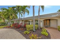 House exterior showcasing landscaping and a brick walkway at 605 Wild Turkey Ln, Sarasota, FL 34236