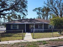 Ranch style home with a green exterior, updated windows, and a fenced yard at 123 Chauncey Ave, Bradenton, FL 34208