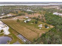 Aerial view of property showing home, expansive land, and pond at 19990 E State Road 64, Bradenton, FL 34212