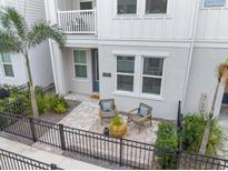 Inviting front patio with two chairs and potted plants at 2462 Mangum Ct, Sarasota, FL 34237
