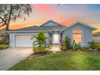 Cute one-story home with a landscaped lawn, attached garage, and a walkway to the front door at 3712 62Nd E Ave, Bradenton, FL 34203