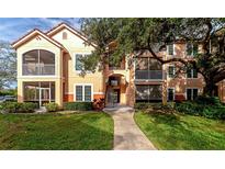 Two-story condo building with balconies and lush landscaping at 4110 Central Sarasota Pkwy # 136, Sarasota, FL 34238