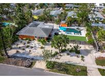 Aerial view of mid-century modern home with pool and lush landscaping at 711 Russell St, Longboat Key, FL 34228