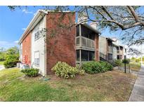 Brick building exterior with screened balcony and landscaping at 9100 Dr Martin Luther King Jr N St # 1302, St Petersburg, FL 33702