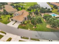 Bird's eye view of house, pool, golf course, and lake at 9414 Forest Hills Cir, Sarasota, FL 34238