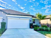 Attractive single-story home with a two-car garage and landscaped front yard at 6014 Fiore Dr, Bradenton, FL 34208