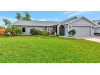 Well-maintained single story home with a spacious lawn and attached garage at 2154 Lakewood Dr, Nokomis, FL 34275