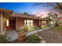 Charming home featuring a welcoming entrance, well-manicured landscaping, and a beautiful walkway at 2218 Shadow Oaks Rd, Sarasota, FL 34240