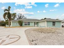 Light teal house with a circular driveway and mature landscaping at 2808 68Th Street W Cir, Bradenton, FL 34209