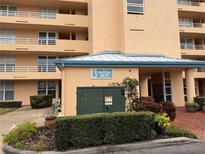 Exterior view of a condo building with landscaping and parking at 4570 Pinebrook Cir # 303, Bradenton, FL 34209