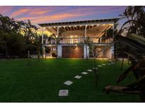 Elevated home with covered porch, walkway, and lush lawn at 543 Hillcrest Dr, Bradenton, FL 34209