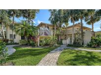 Condo building with palm trees and brick walkways at 6450 Wild Oak Bay Blvd # 238, Bradenton, FL 34210