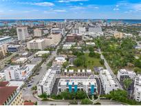 Aerial view of modern townhouses with city skyline in background at 72 N School Ave, Sarasota, FL 34237