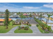 Aerial view of waterfront home with pool and landscaped yard at 740 Old Compass Rd, Longboat Key, FL 34228