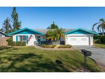 Charming single-story home with well-manicured lawn, blue trim, and attached garage at 807 62Nd W St, Bradenton, FL 34209