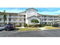 Two-story condo building with parking and landscaping at 8750 Olde Hickory Ave # 9205, Sarasota, FL 34238