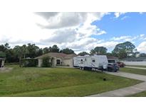 Single-Gathering home with RV parking and a spacious yard at 1649 N Chamberlain Blvd, North Port, FL 34286